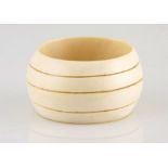 A large carved ivory bangle incised with four parallel bands Not suitable for export 1 inner