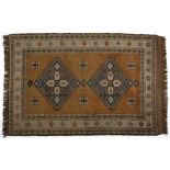 A Turkish Rug, Modern the madder field with two diamond medallions depicted in slate blue within a