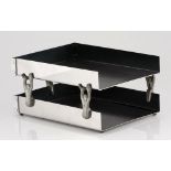 A stainless steel and pewter paper tray, Carrol Boyes, modern two tiered, with stylised figural