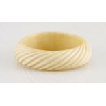 A carved ivory bangle of spiral-twist design NOT SUITABLE FOR EXPORT 1 inner diameter 65mm diameter