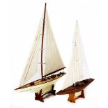 Two wooden models of yachts, 20th century each with canvas sails and assorted rigging and deck