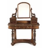 A VICTORIAN MAHOGANY DRESSING TABLE the moulded shaped top surmounted by two pairs of short pedestal