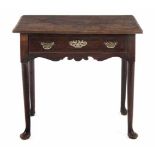 A GEORGE III OAK SIDE TABLE the moulded rectangular top above a long frieze drawer, shaped apron, on