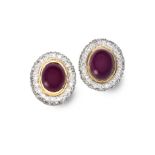 A PAIR OF RUBY AND DIAMOND EARRINGS each centred with an oval-shaped cabochon ruby weighing