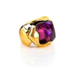 AN AMETHYST RING after the 'Piramide' design by Bulgari, of angular bombé design, centred with a