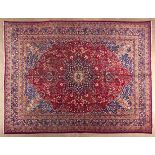 A KESHAN CARPET,PERSIA,MODERN the red field with a slate-blue and ivory floral medallion, similar