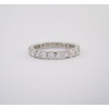 A DIAMOND ETERNITY RING set throughout with brilliant-cut diamonds weighing approximately 1.15cts in