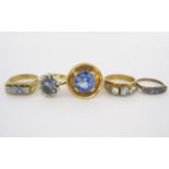 A MISCELLANEOUS GROUP OF FIVE GEM-SET RINGS of various designs and sizes, each claw set with blue-
