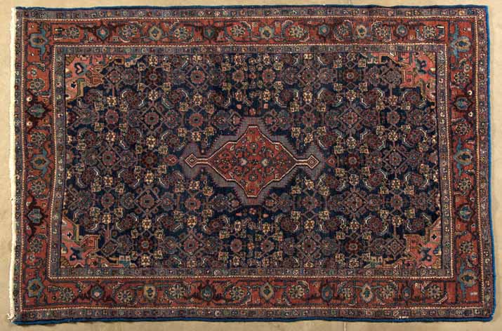 A HAMADAN RUG,PERSIA,CIRCA 1960 the deep blue field with a stepped madder-red medallion, similar