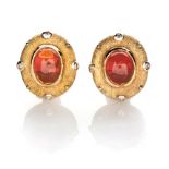 A PAIR OF FIRE OPAL AND DIAMOND EARRINGS, SCHWARTZ each centred with an oval cabochon fire opal