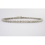 A DIAMOND TENNIS BRACELET each circular link set with a brilliant-cut diamond weighing approximately