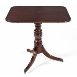A VICTORIAN MAHOGANY TILT-TOP TABLE the rounded rectangular top above a ring-turned support, on