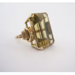 A CITRINE RING claw set with an emerald-cut citrine weighing approximately 17.61cts, the basket with