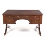 A REGENCY MAHOGANY KNEEHOLE DESK the rectangular rounded top with a gilt-tooled leather-inset