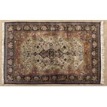 A QUM SILK RUG,PERSIA,MODERN the ivory field with a dark indigo-blue floral star medallion,