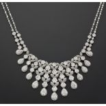 A DIAMOND NECKLACE designed to the centre as a graduated fringe of flower heads and foliage