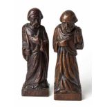 TWO CONTINENTAL CARVED OAK FIGURES OF SAINTS each standing, one holding a palm leaf, the other a