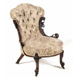 A VICTORIAN MAHOGANY AND UPHOLSTERED NURSING CHAIR the padded button-back between foliate-carved and