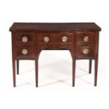 AN EDWARDIAN MAHOGANY SIDEBOARD the serpentine-fronted top above a central frieze drawer flanked