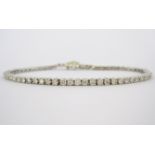 A DIAMOND TENNIS BRACELET claw set with brilliant-cut diamonds weighing approximately 3.35cts in