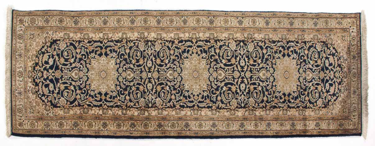 AN INDO-PERSIAN RUNNER,MODERN the deep indigo-blue field with three floral ivory star medallions,