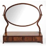 A FLAME MAHOGANY GENTLEMAN'S TOILET MIRROR, 19TH CENTURY the oval plate within a conforming frame