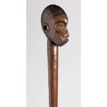 A MAKONDE STAFF, MOCAMBIQUE the handle carved as a face with scarification 81cm long (1)