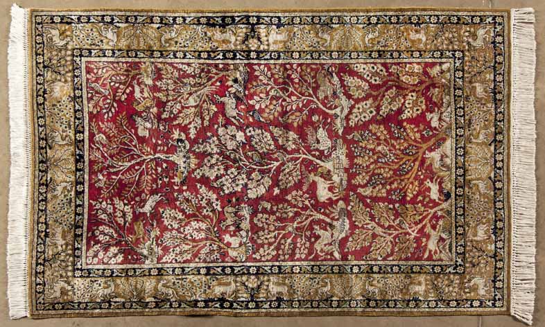 A QUM SILK RUG,PERSIA,MODERN the red field with ascending flowering trees, animals and perching