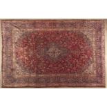 A MESHED CARPET,EAST PERSIA,MODERN the red field with an indigo-blue and ivory star medallion,