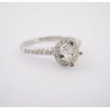 A DIAMOND RING claw set to the centre with a round brilliant-cut diamond weighing 0.5020cts, the