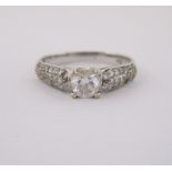 A DIAMOND RING centred with a claw-set brilliant-cut diamond weighing approximately 0.39cts, the