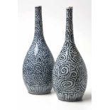 A PAIR OF JAPANESE BLUE AND WHITE BOTTLE VASES, MEIJI, 1868-1912 each painted overall with dense