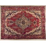 A TABRIZ CARPET, NORTH WEST PERSIA, CIRCA 1960 the red field with a sky-blue floral medallion and