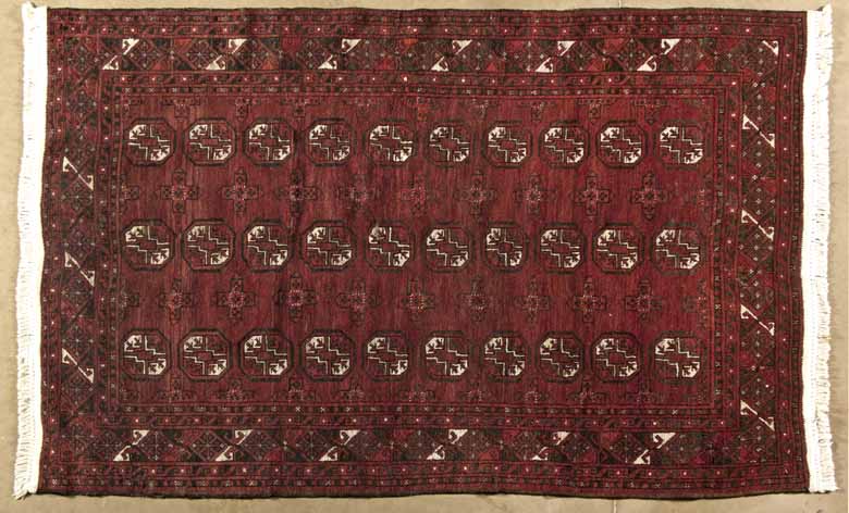 AN AFGHAN RUG,MODERN the red field with three rows of ten guls depicted in ivory,red and walnut