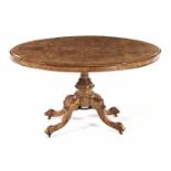 A VICTORIAN WALNUT AND INLAID OVAL TABLE the quarter-veneered top on a turned column, drum socle, on