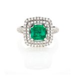 AN EMERALD AND DIAMOND RING centred with a square emerald-cut emerald weighing approximately 1.