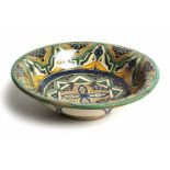 A MOROCCAN POTTERY FOOTED BOWL, LATE 19TH CENTURY painted with an Arabesque design in shades