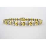 A DIAMOND BRACELET, SCHWARTZ designed as a series of yellow-gold, heart-shaped links alternating