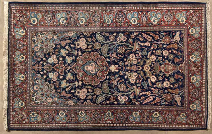 A KESHAN PRAYER RUG, PERSIA,MODERN the deep indigo-blue mehrab with a small floral medallion and