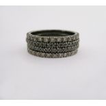 A SET OF FOUR DIAMOND ETERNITY RINGS two set throughout with black circular-cut diamonds and two set