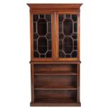 AN EDWARDIAN MAHOGANY AND INLAID BOOKCASE the moulded outswept cornice above a cross-banded