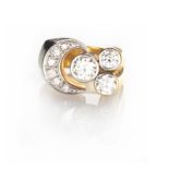 A DIAMOND RING of asymmetrical design, collet set with three brilliant-cut diamonds weighing