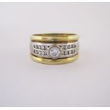 A DIAMOND RING designed as three bands, the central tapered white-gold band centred with a collet-