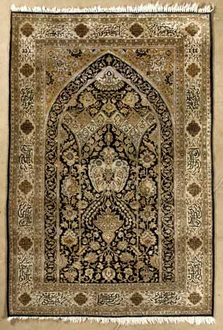 A QUM SILK PRAYER RUG.PERSIA,MODERN the black mehrab with a uni-directional design of trees,