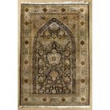 A QUM SILK PRAYER RUG.PERSIA,MODERN the black mehrab with a uni-directional design of trees,