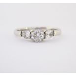 A DIAMOND RING, BROWNS claw set to the centre with a brilliant-cut diamond weighing approximately