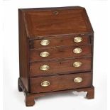 A GEORGE III MAHOGANY BUREAU the hinged fall-front enclosing drawers and compartments, in sizes,