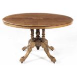 A VICTORIAN WALNUT TABLE the oval quarter-veneered top above a plain frieze, on five turned
