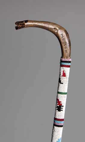 A ZULU BEADED STAFF the handle carved in the form of a snake's head, inscribed Madon 86,5cm long (