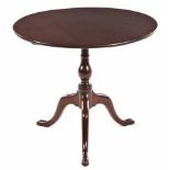 A GEORGE III MAHOGANY TRIPOD TABLE the circular top above a baluster-shaped support, on hipped legs,